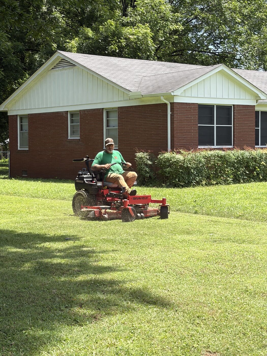 Grizzly Lawn Co. mowing a residential yard